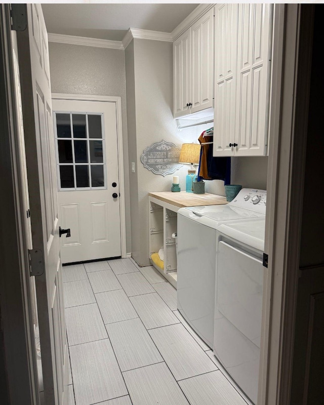 clothes washing area featuring separate washer and dryer, cabinet space, and crown molding
