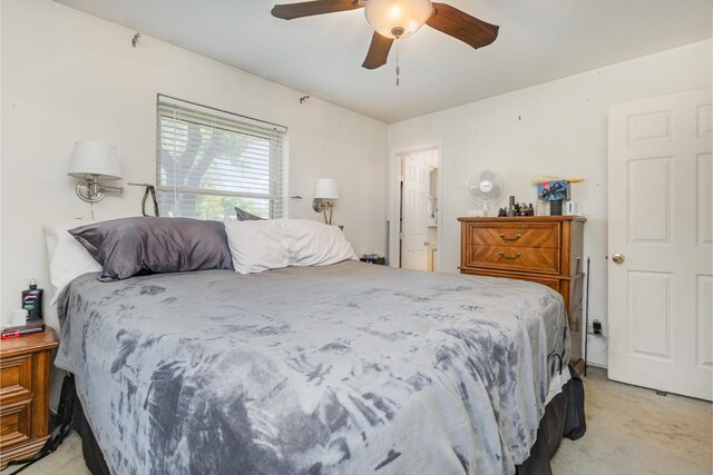 bedroom with ceiling fan, multiple windows, and light carpet