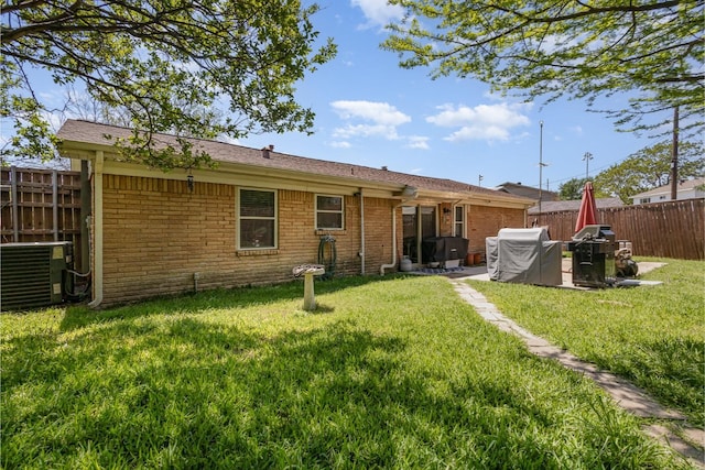 735 Sara Dr, Mesquite, TX 75149 - rear view of property with cooling unit, brick siding, and a patio area