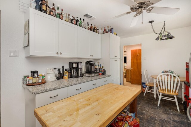 kitchen featuring visible vents, white cabinetry, appliances with stainless steel finishes, and light stone countertops