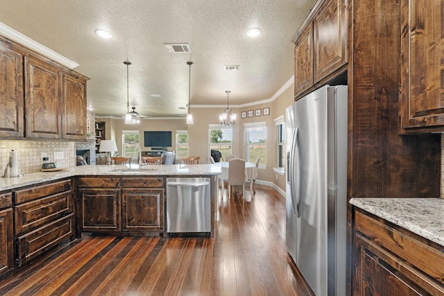kitchen featuring stainless steel appliances, visible vents, a sink, and dark wood-type flooring
