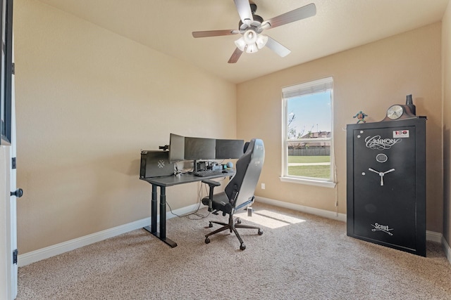 home office featuring carpet, a ceiling fan, and baseboards