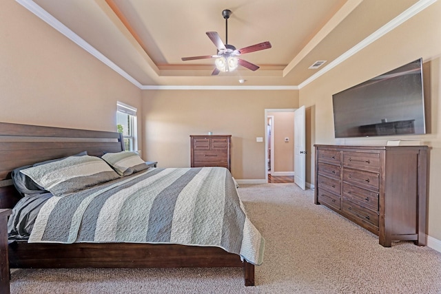 bedroom with a tray ceiling, visible vents, baseboards, light colored carpet, and ceiling fan