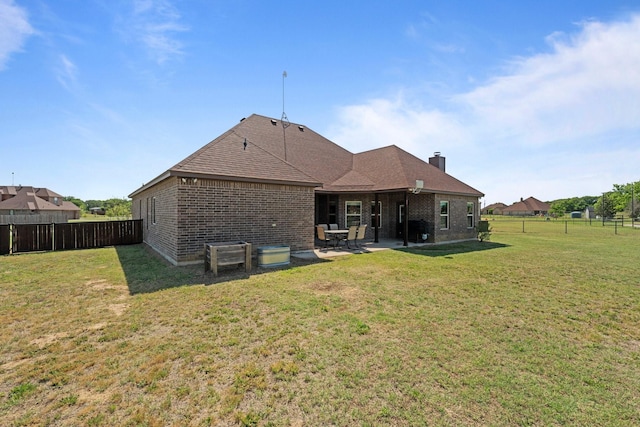 back of property featuring brick siding, a patio, and a fenced backyard