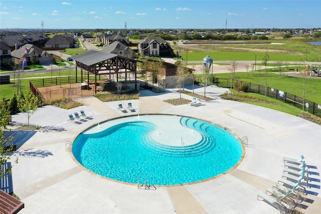 pool with fence, a gazebo, a residential view, and a patio