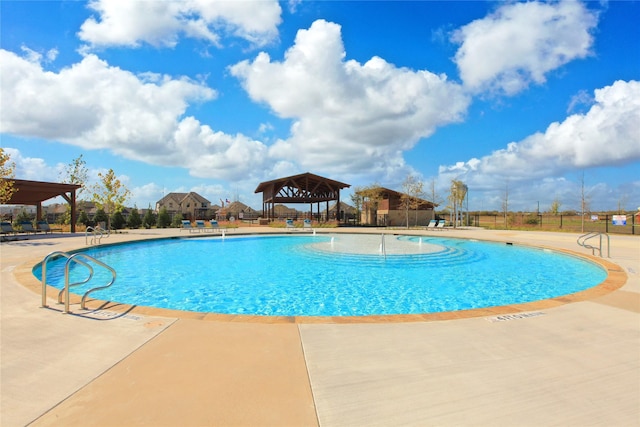 community pool featuring a gazebo, a patio, and fence