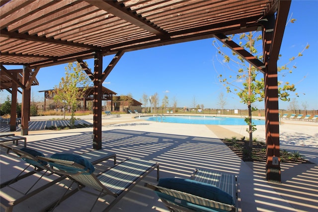 pool featuring a pergola, fence, and a patio area