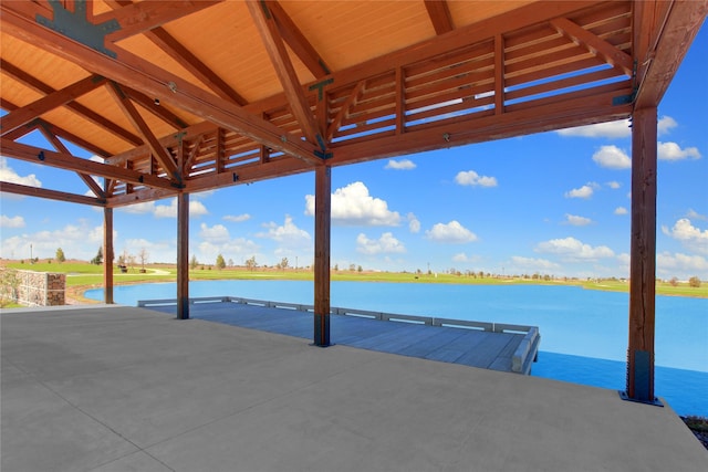view of dock featuring a patio and a water view
