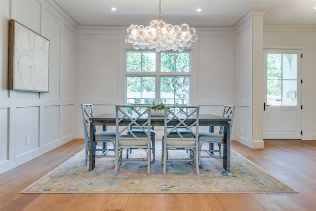 7206 Northaven Rd, Dallas, TX 75230 - dining room featuring an inviting chandelier, a decorative wall, crown molding, and light wood-style floors