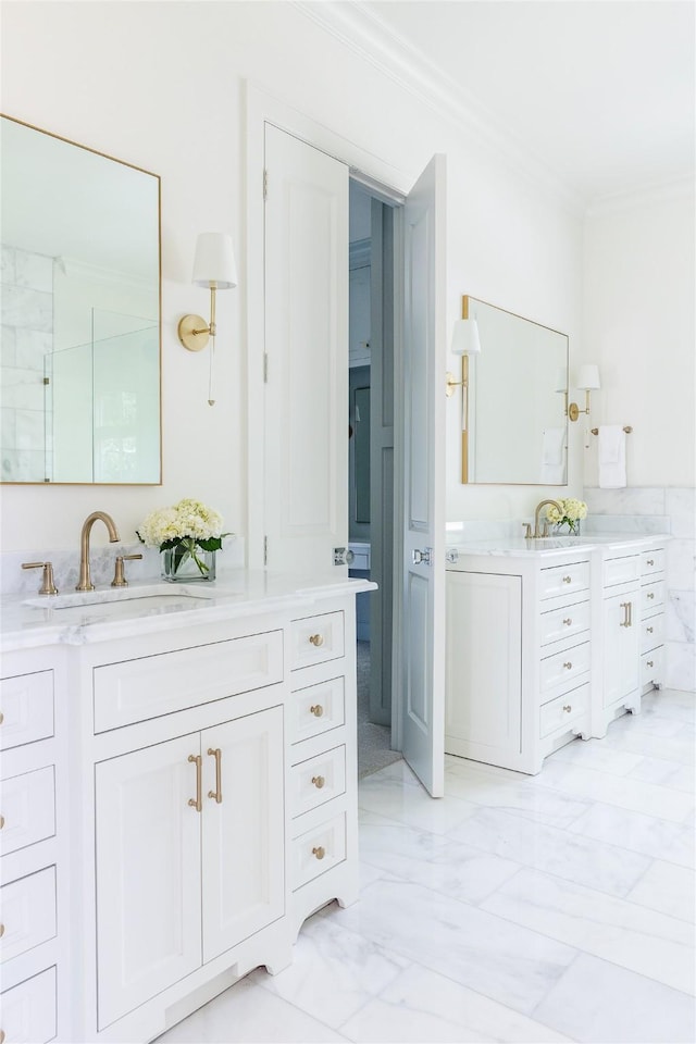 7206 Northaven Rd, Dallas, TX 75230 - bathroom featuring two vanities, marble finish floor, ornamental molding, and a sink