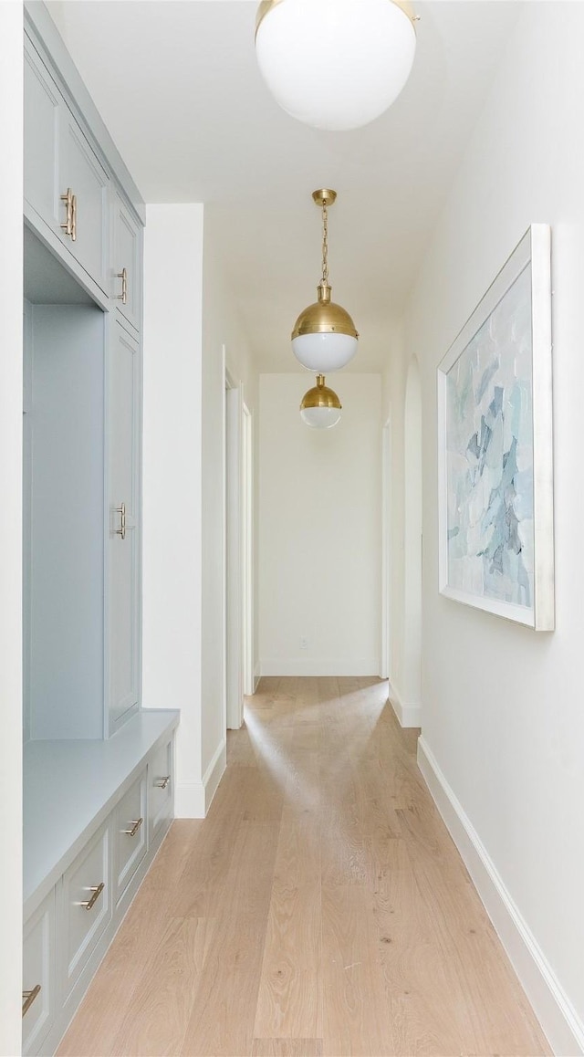 7206 Northaven Rd, Dallas, TX 75230 - mudroom with baseboards, light wood-style flooring, and arched walkways