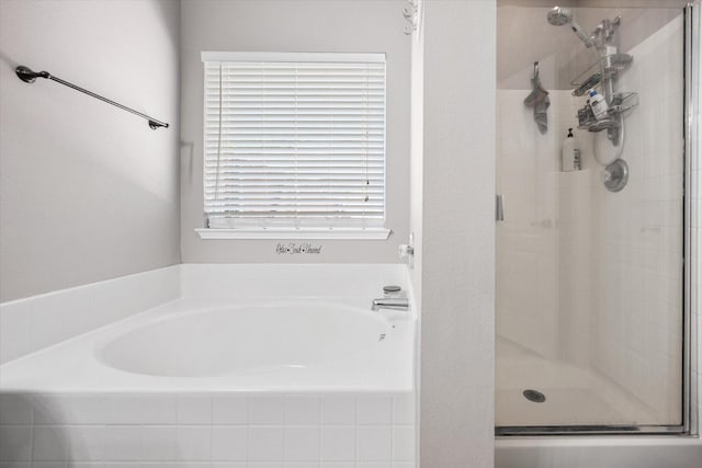 full bathroom featuring a garden tub and a stall shower