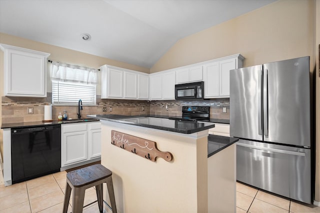 kitchen with light tile patterned floors, white cabinets, a sink, and black appliances