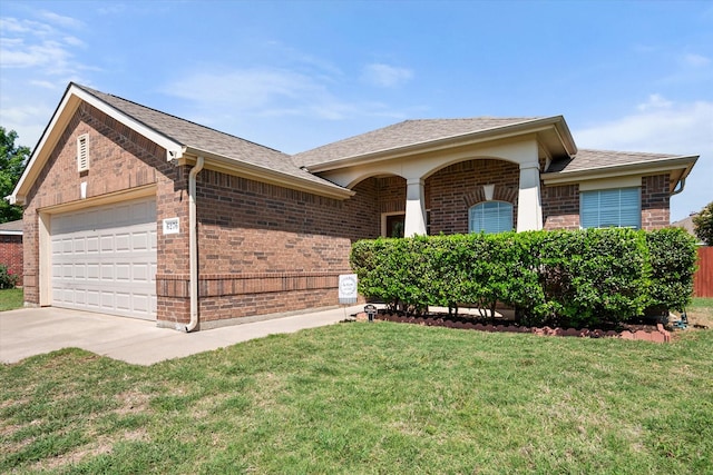 ranch-style home with brick siding, a front yard, and a garage