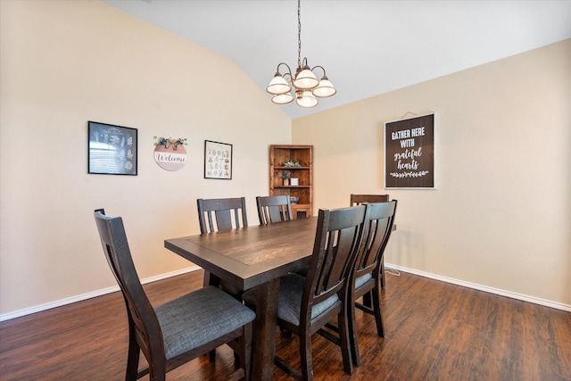 dining room featuring a chandelier, dark wood finished floors, lofted ceiling, and baseboards