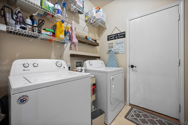 washroom featuring washer and clothes dryer, light tile patterned floors, and laundry area