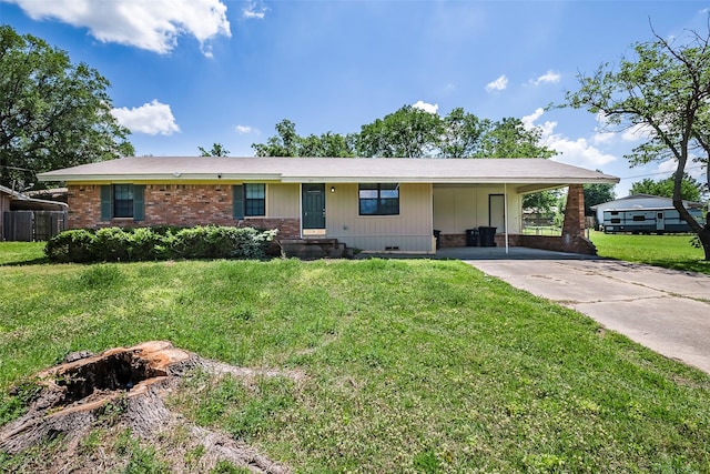 ranch-style home with a carport, brick siding, a front yard, and concrete driveway