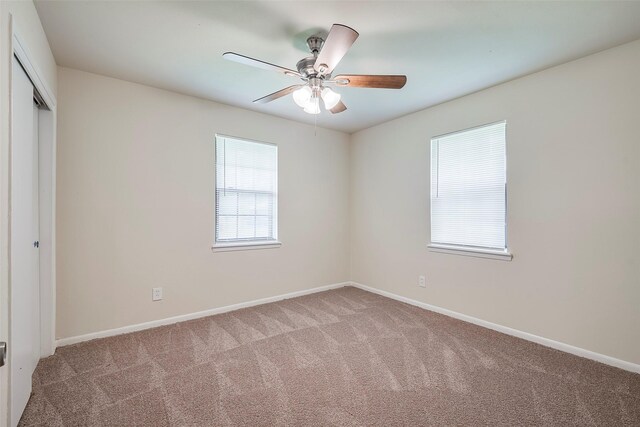 unfurnished room with baseboards, carpet, and ceiling fan