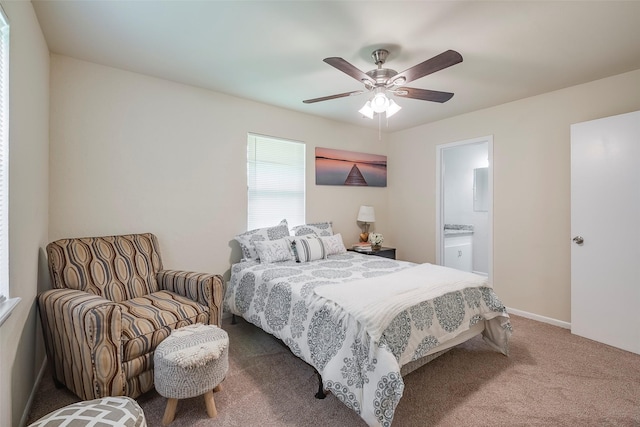 bedroom with a ceiling fan, carpet, and connected bathroom