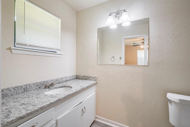 bathroom with toilet and vanity