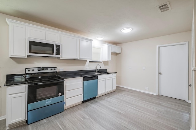 kitchen featuring dishwasher, visible vents, a sink, white microwave, and black electric range oven