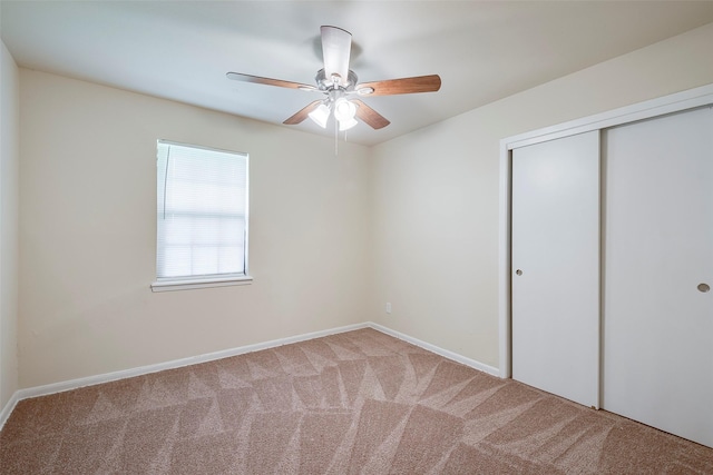 unfurnished bedroom featuring baseboards, carpet, a closet, and ceiling fan
