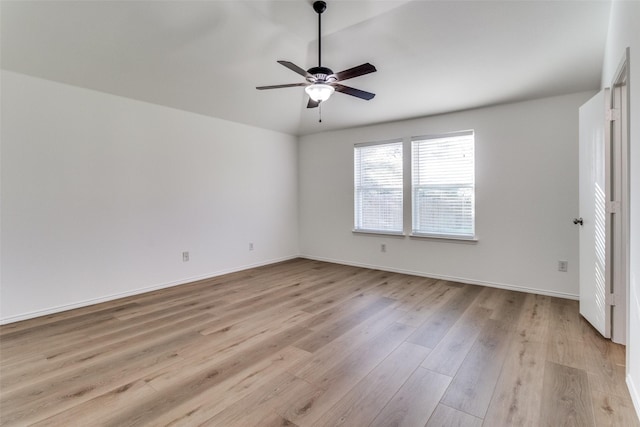 empty room with light wood-style flooring, a ceiling fan, and baseboards