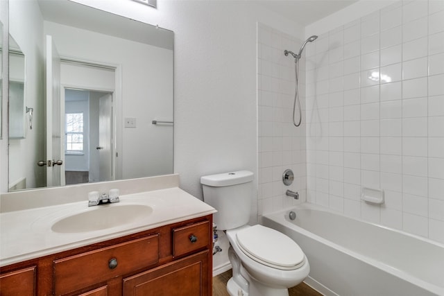 bathroom featuring toilet, vanity, and shower / tub combination