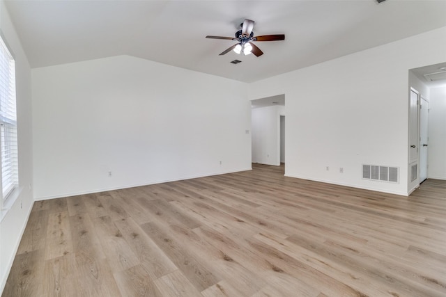 unfurnished living room with light wood-type flooring, plenty of natural light, a ceiling fan, and visible vents