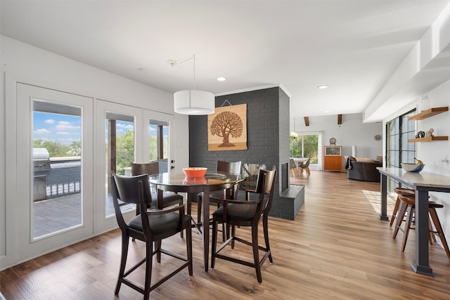 dining area featuring french doors, a wealth of natural light, recessed lighting, and light wood-style flooring