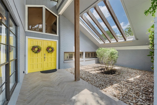 view of exterior entry with brick siding
