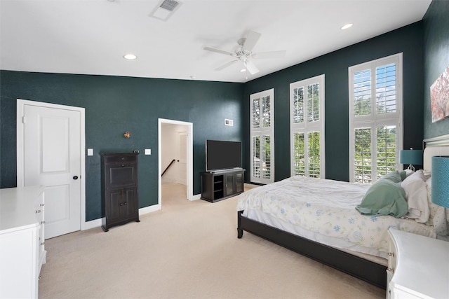 bedroom featuring light carpet, multiple windows, and recessed lighting