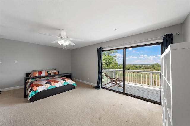 carpeted bedroom with access to exterior, a ceiling fan, and baseboards