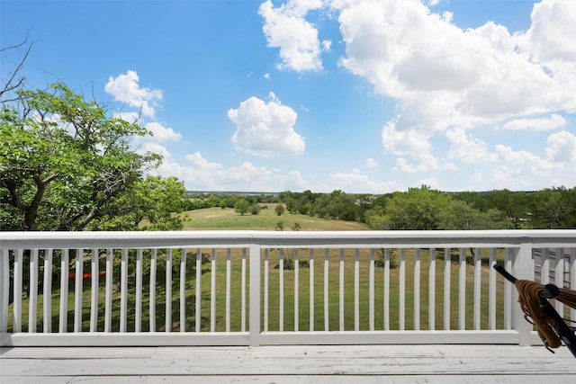 wooden terrace with a lawn