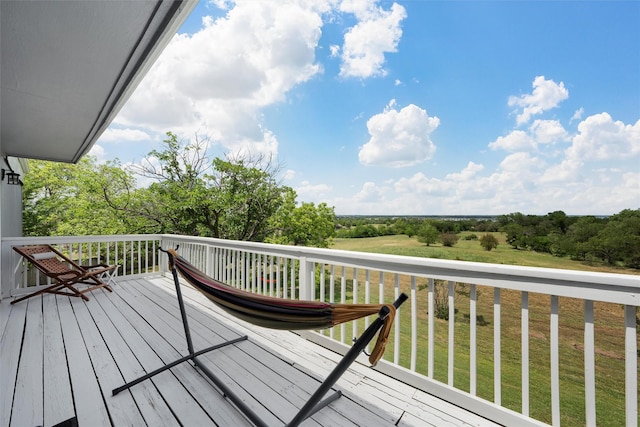 wooden deck with a lawn