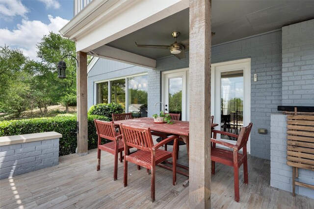 wooden deck with a ceiling fan and outdoor dining area