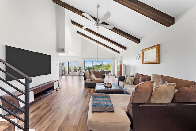 living area with high vaulted ceiling, stairs, wood finished floors, ceiling fan, and beam ceiling