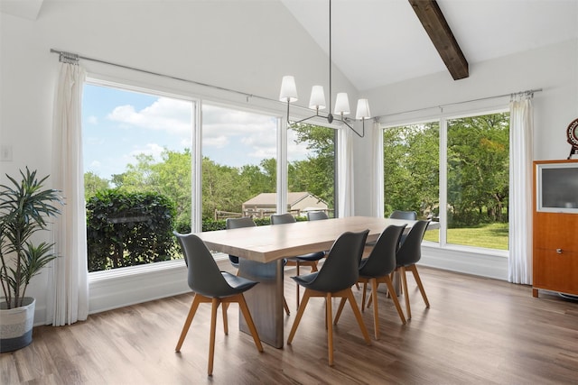 dining area featuring lofted ceiling with beams, wood finished floors, and a notable chandelier
