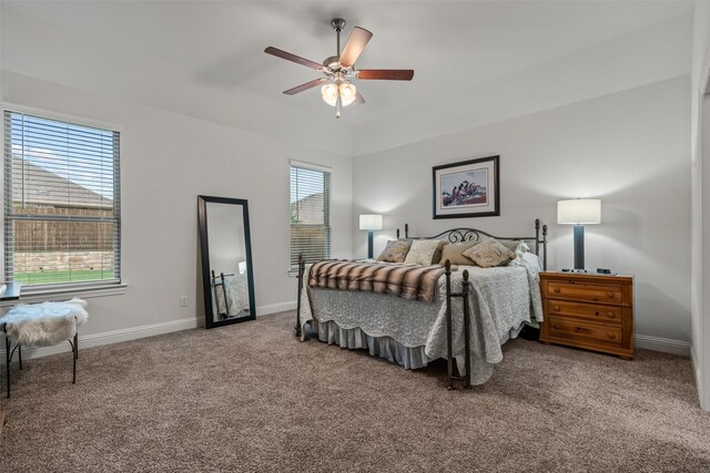 carpeted bedroom with a ceiling fan and baseboards