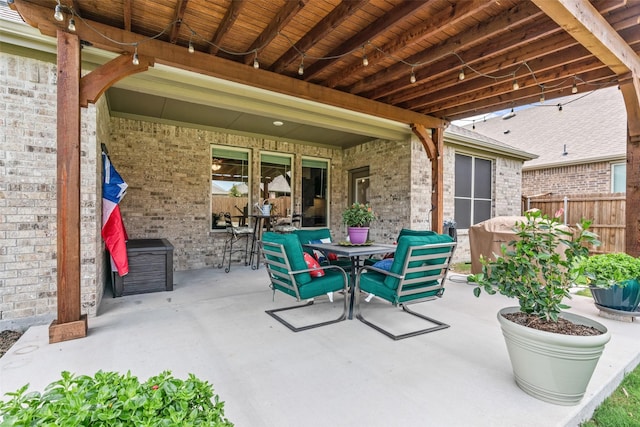 view of patio / terrace with outdoor dining area and fence