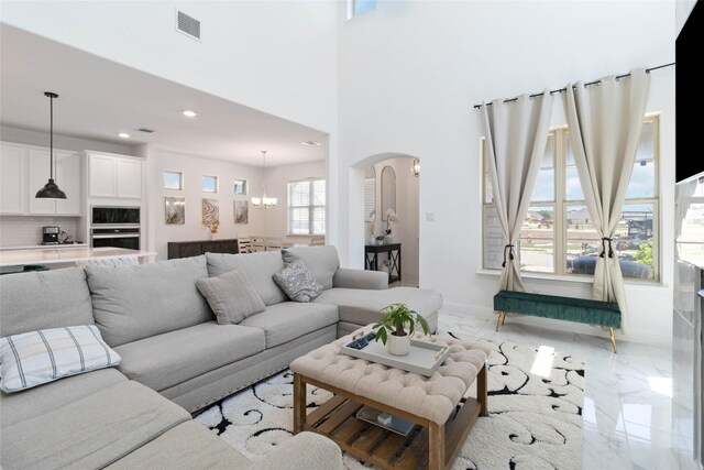 1313 Canuela Way, Justin, TX 76247 - living room with recessed lighting, marble finish floor, an inviting chandelier, visible vents, and arched walkways