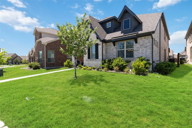 1313 Canuela Way, Justin, TX 76247 - view of front of home with stone siding, a shingled roof, and a front yard
