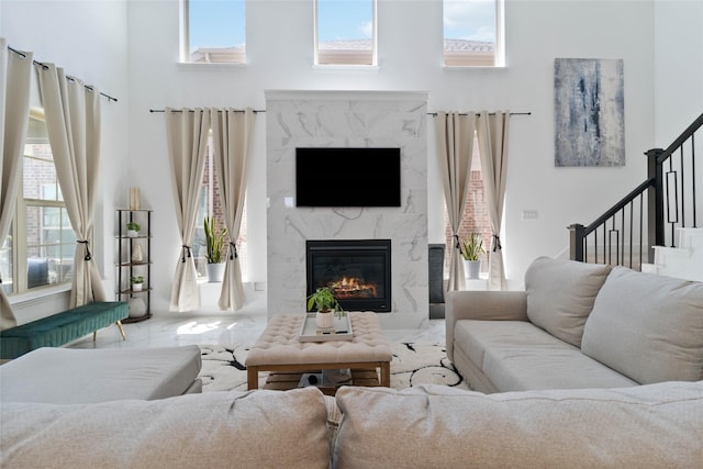 1313 Canuela Way, Justin, TX 76247 - living area with a fireplace, a high ceiling, and stairs