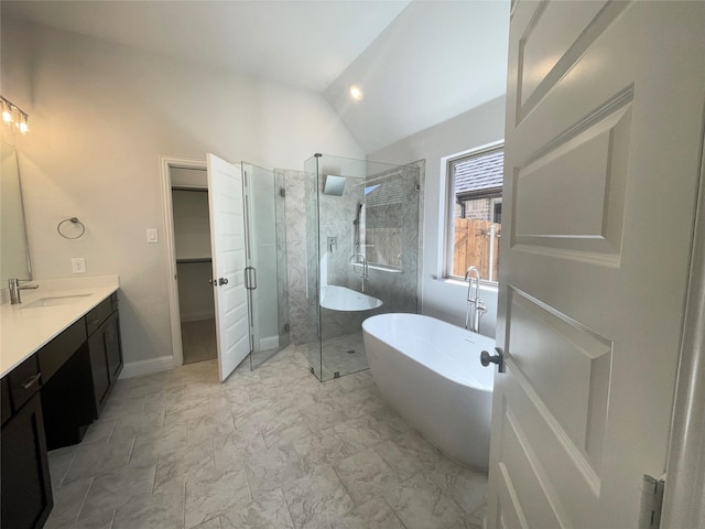 6109 Rodin Dr, Royse City, TX 75189 - bathroom with a stall shower, lofted ceiling, a freestanding tub, vanity, and a walk in closet
