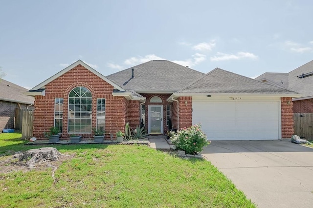 ranch-style home featuring fence, a front lawn, driveway, brick siding, and a garage