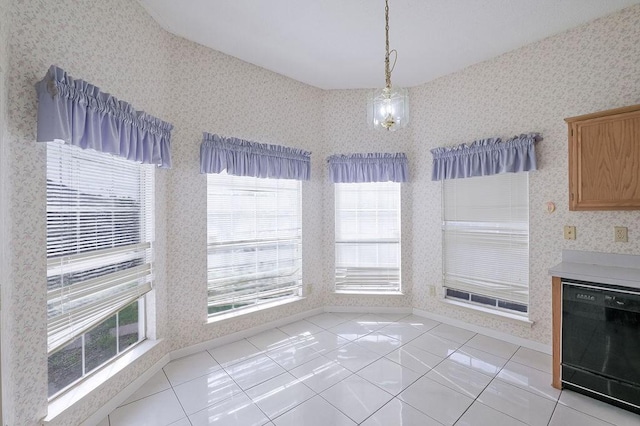 unfurnished dining area featuring wallpapered walls and light tile patterned floors