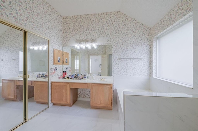 full bathroom featuring lofted ceiling, vanity, and wallpapered walls