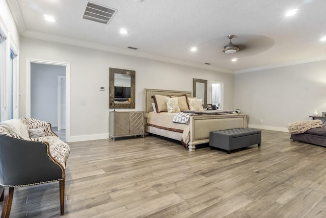 bedroom with light wood-style floors, visible vents, and crown molding