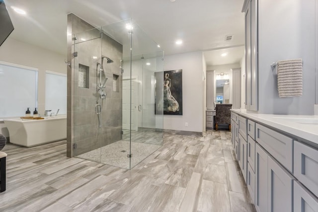 full bath with a stall shower, vanity, a soaking tub, visible vents, and recessed lighting