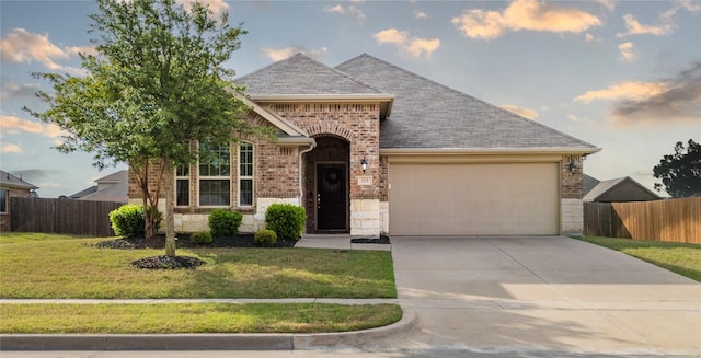 view of front of home with brick siding, concrete driveway, a garage, and fence